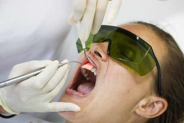Dentist,Using,A,Modern,Diode,Dental,Laser,For,Periodontal,Care.